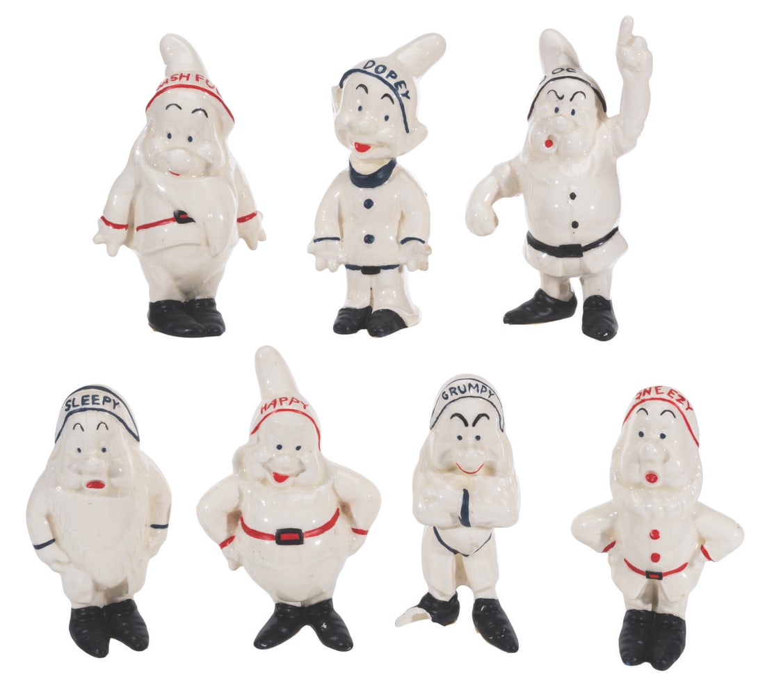A Set of "Snow White and the Seven Dwarfs" Figurines.: (1950s-60s) A set of eight seven Dwarf figurines, white with colored accents. Ranging in size from 4.5" to 5.5" tall, the "Snow White and the Seven Dwarfs" ceramic figurines are in fair to good condit