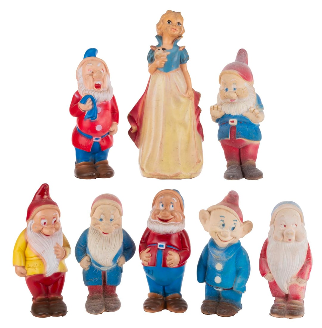 A Set of Snow White and the Seven Dwarfs Plastic Figures.: (Disney, 1950s-70s) A set of eight squeeze toys of Snow White and the Seven Dwarfs. Each standing from 7.25" to 11" tall, the dolls are in fair condition with wear from age and use.