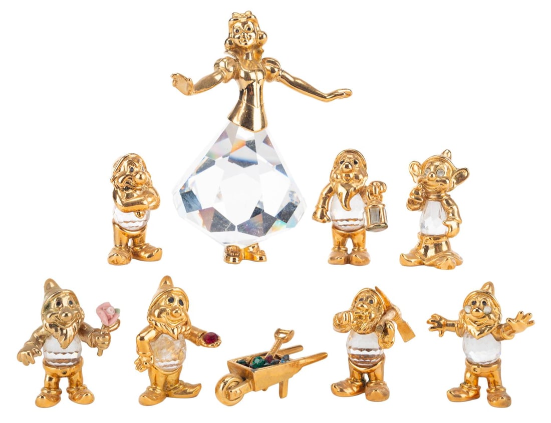 A Set of 24k Gold "Snow White" Crystal Figurines.: (Lencia-Austria, 1980s-90s) An eight-piece Lencia crystal "Snow White and the Seven Dwarfs" set featuring 24k gold plating with Austrian crystal midsections. The set includes Snow White, the Seven Dwa