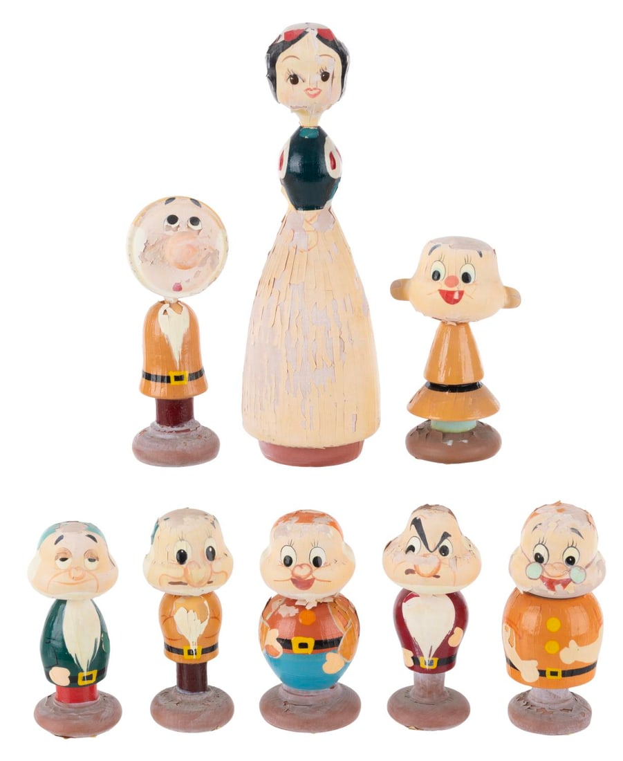 A "Snow White and the Seven Dwarfs" Wooden Figure Set.: (Disney, 1960) A rare hand-painted wooden figure set of "Snow White and the Seven Dwarfs." Standing from 2.5" to 5" tall, the figures are in fair condition with very fragile paint showing spots of los