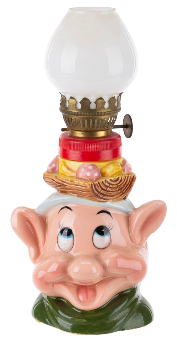A 1960s Dopey Oil Lamp.: (Crown, 1960s) A figural ceramic Dopey oil lamp manufactured by Crown Japan. Measuring 3.5" x 3.5" x 7.5" tall, the ceramic lamp is in very good condition with light wear and spots of paint loss.