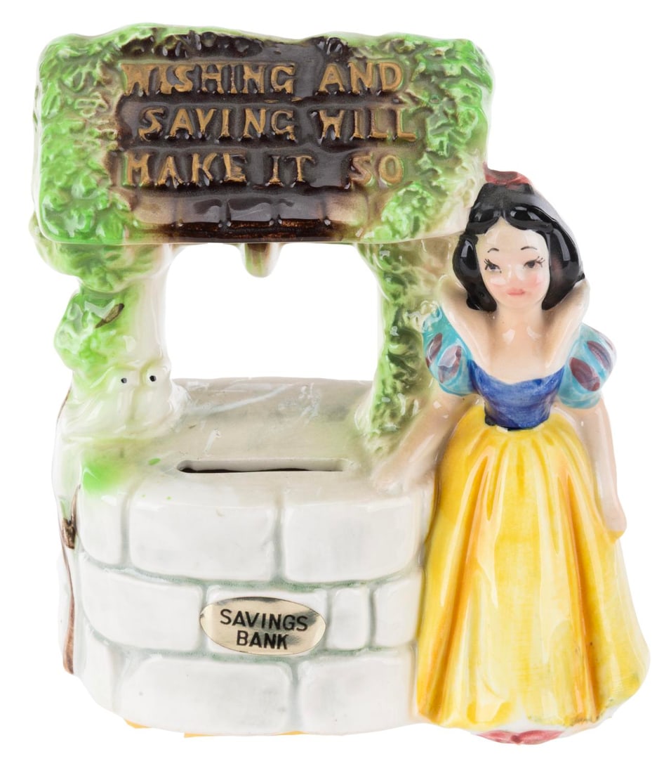 A Snow White Wishing Well Coin Bank.: (Enesco, 1960s) A ceramic savings bank of Snow White at the Wishing Well from "Snow White and the Seven Dwarfs." Measuring 5" x 3" x 4.5" tall, the ceramic bank is in very good condition with spots of