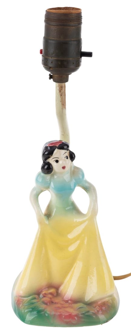 A Snow White Ceramic Lamp by Leeds China.: (Leeds China, 1940s) A "Snow White and the Seven Dwarfs" lamp by Leeds China, which held a license for Disney Pottery starting in 1944. Measuring 4.5" x 4" x 11" tall, the ceramic lamp worked when tes
