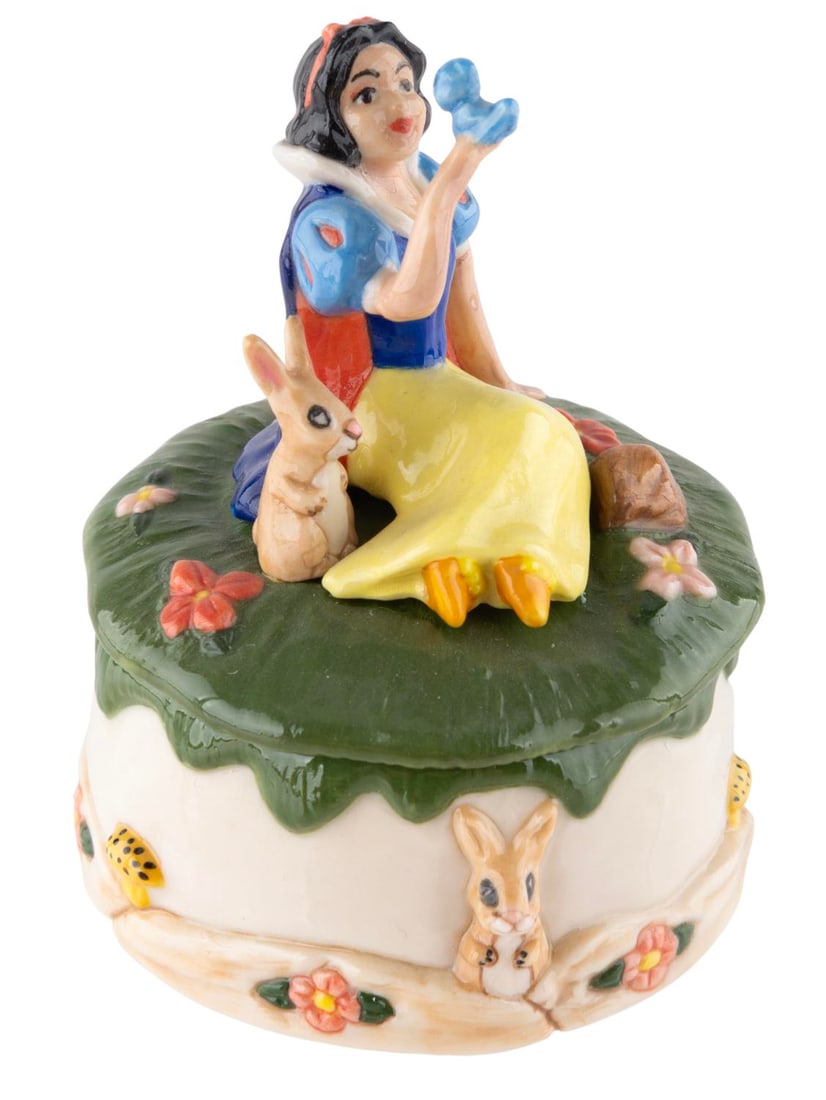 A Michael Lawrence Snow White Ceramic Trinket Box.: (Walt Disney Gallery, 1990s) A ceramic trinket box of Snow White with a rabbit figurine inside, produced by Michael Lawrence for the Walt Disney Gallery. Measuring 2" in diameter x 2.75" tall, the pie