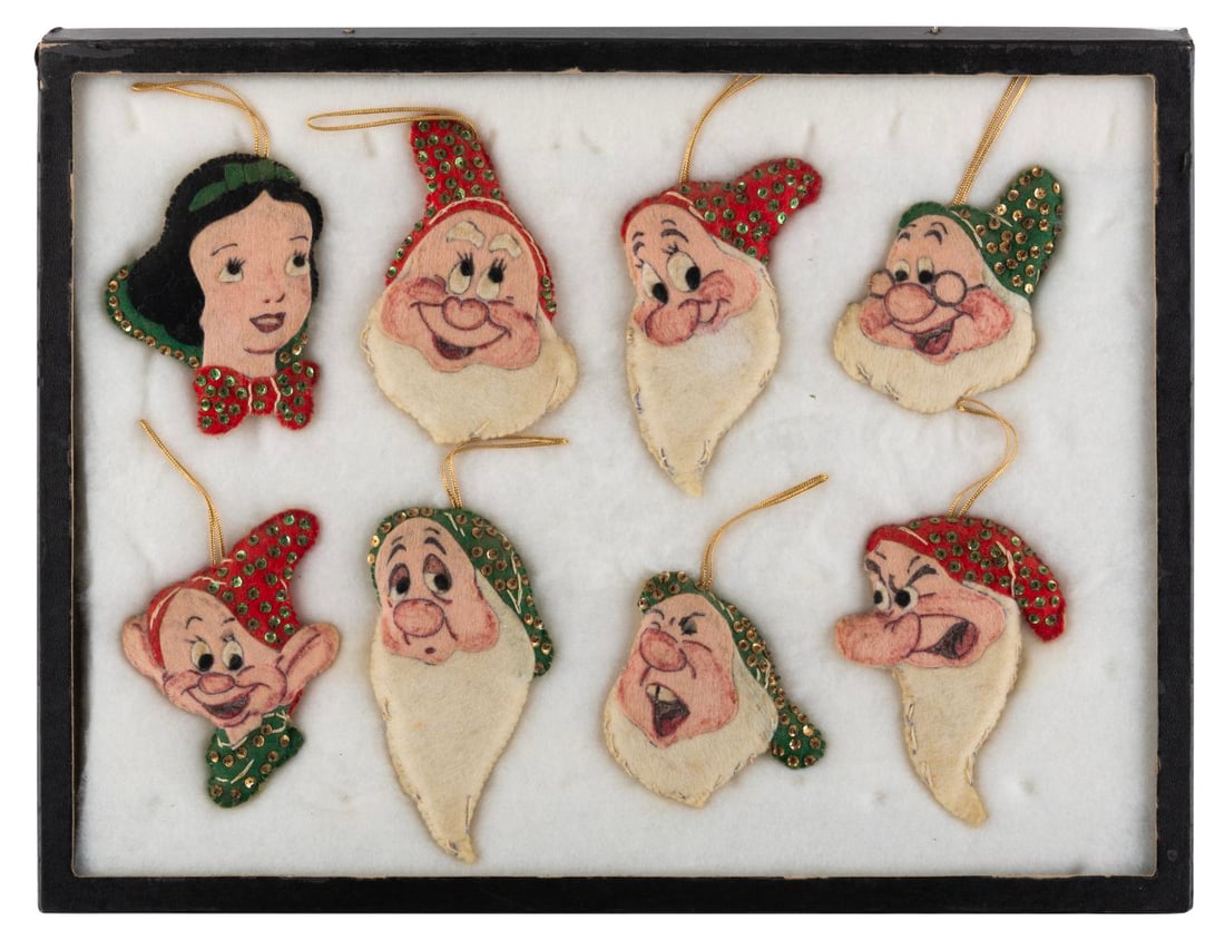 A "Snow White and the Seven Dwarfs" Felt Ornament Set.: (Disney, 1970s) A set of eight felt ornaments of "Snow White and the Seven Dwarfs." Measuring up to 5" x 2.75", the set is in good condition with wear from age and use.