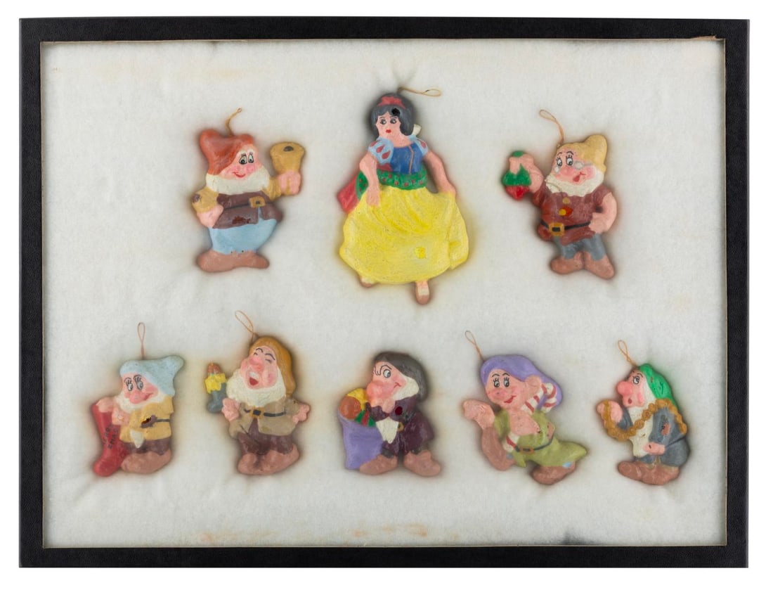 A "Snow White and the Seven Dwarfs" Ornament Set.: (Disney, 1970s) A set of eight plaster or resin hand-painted ornaments of "Snow White and the Seven Dwarfs." Measuring up to 4.5" x 2.75", the set is in good condition with wear from age and use, some