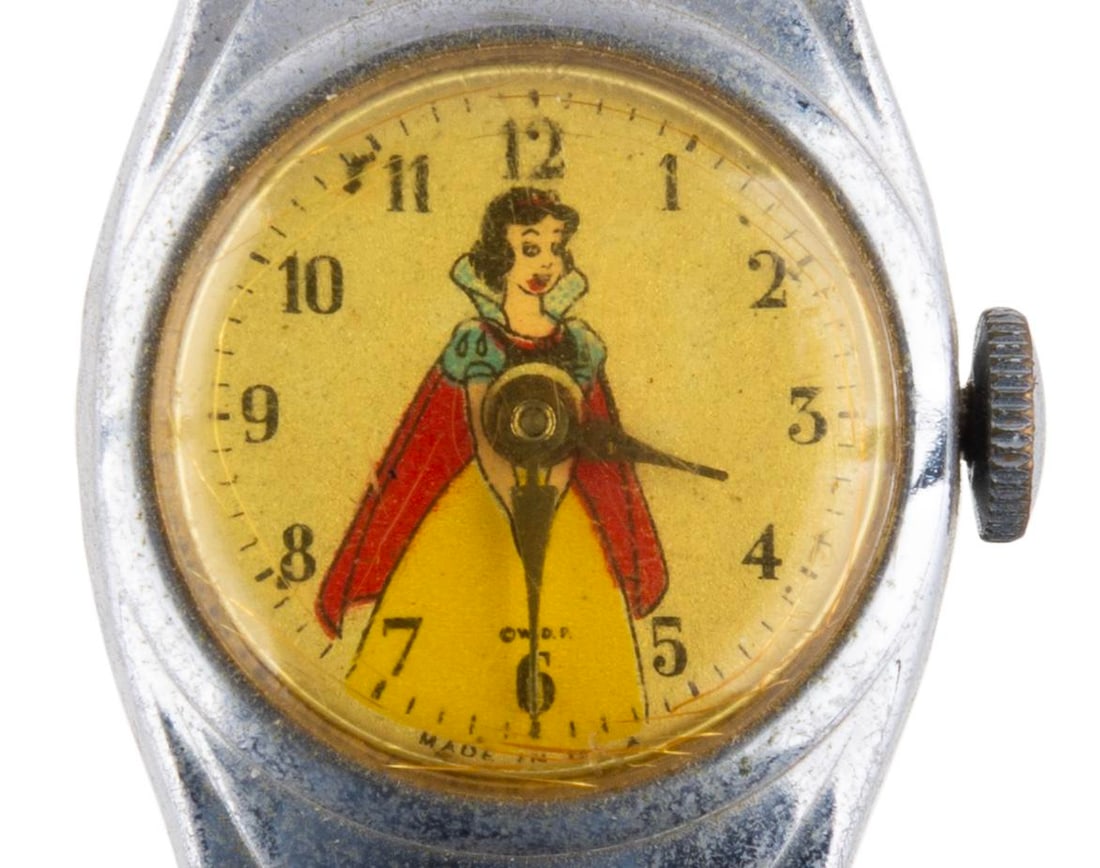 A 1950s Snow White Wristwatch.: (US Time, 1950s) A children's Snow White watch with metal band. The watch is in good condition with one loose link in the band, and requiring service to function.