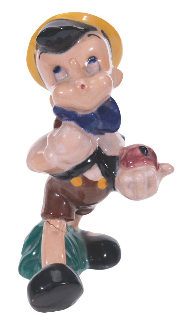 A Pinocchio Figurine by Brayton Laguna.: (Brayton Laguna, 1940s) A painted glazed ceramic figurine of Pinocchio produced by Brayton Laguna. Measuring 6" tall, the ceramic figurine displays in fair condition with crazing throughout, spots of