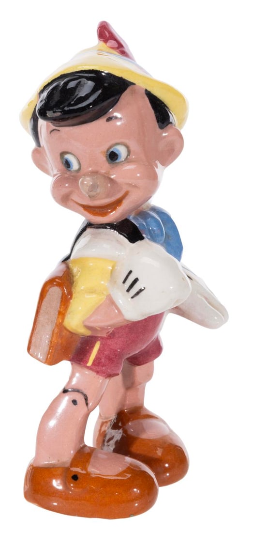A 1940s Evan K. Shaw "Pinocchio" Figurine.: (Shaw, 1940s) A ceramic figurine of Pinocchio manufactured by Evan K. Shaw. Measuring 6.5" tall, the figurine is in good condition with scuffs, crazing, spots of discoloration, and minor production