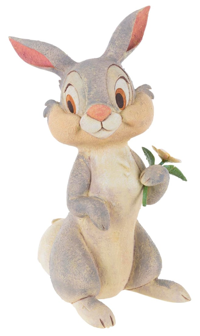 A Disney Store Thumper Garden Statue.: (Disney, 2000s) A garden statue of Thumper from "Bambi," originally sold by the Disney Store. Measuring 7.5" x 5" x 12.5" tall, Thumper displays in very good condition with the flower broken loose wit