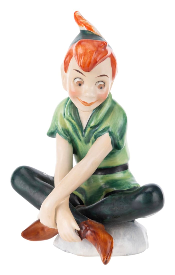 A Goebel "Peter Pan" Ceramic Figurine.: (Goebel, 1959) A ceramic figurine of Peter Pan, manufactured by the renowned Goebel of Germany. Measuring 4.5" tall, the figurine is in good condition with paint loss, scratches, spots of discoloratio