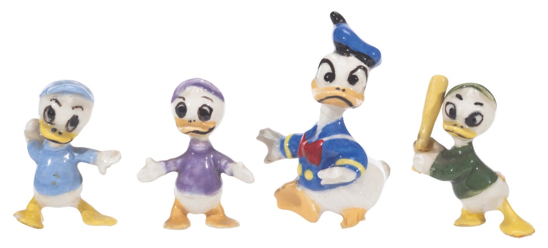 A Collection of Hagen-Renaker Donald Duck and Nephews Figurines.: (Hagen-Renaker, 1950s-60s) A collection of four Hagen-Renaker figurines of Donald Duck, and his nephews, Huey, Dewey, and Louie. Ranging in size from 1" to 1.5", the ceramic figurines are in good to v