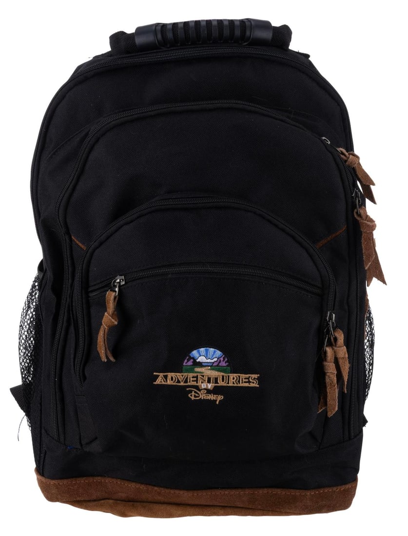 An Adventures by Disney Backpack.: (Disney, 2000s) A backpack featuring the logo for Adventures by Disney, the travel tour service provided by the company. The adjustable backpack is in very good condition with light wear and minor