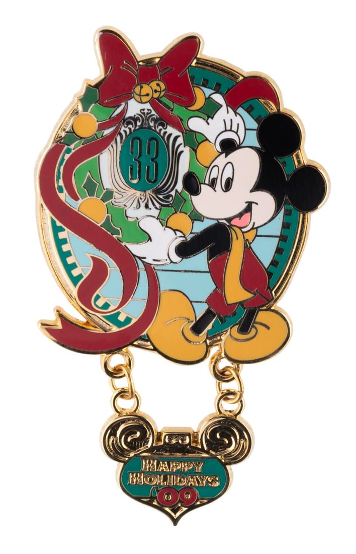 A Club 33 Mickey Mouse Happy Holidays 2009 Pin.: (Disneyland, 2009) A Mickey Mouse Happy Holidays pin with dangle feature, released exclusively at Club 33. The pin is in fine condition.
