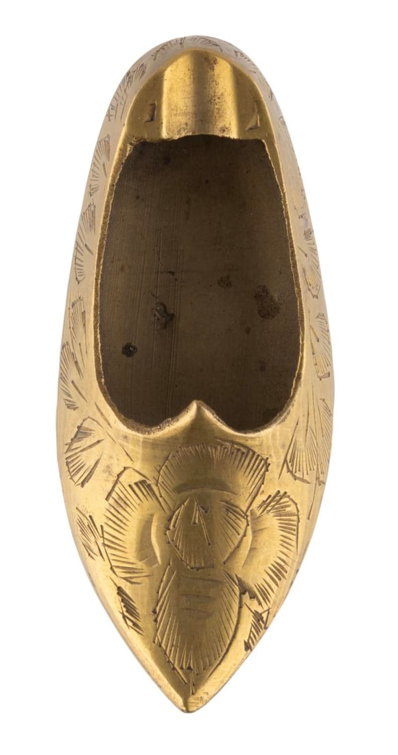 A Disneyland Souvenir Brass Shoe Ashtray.: (Disneyland, 1950s/60s) A small brass ashtray shaped like a shoe. This was made in India and sold at Disneyland, and still retains a partial Disneyland price sticker on the bottom. Measuring 3.25" x 1