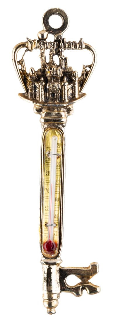 A Disneyland Sleeping Beauty Castle Thermometer.: (Mementos, 1960s) A souvenir Disneyland key-shaped thermometer featuring a three-dimensional Sleeping Beauty Castle with "Disneyland." Measuring 5.25" long, the thermometer is in very good condition.