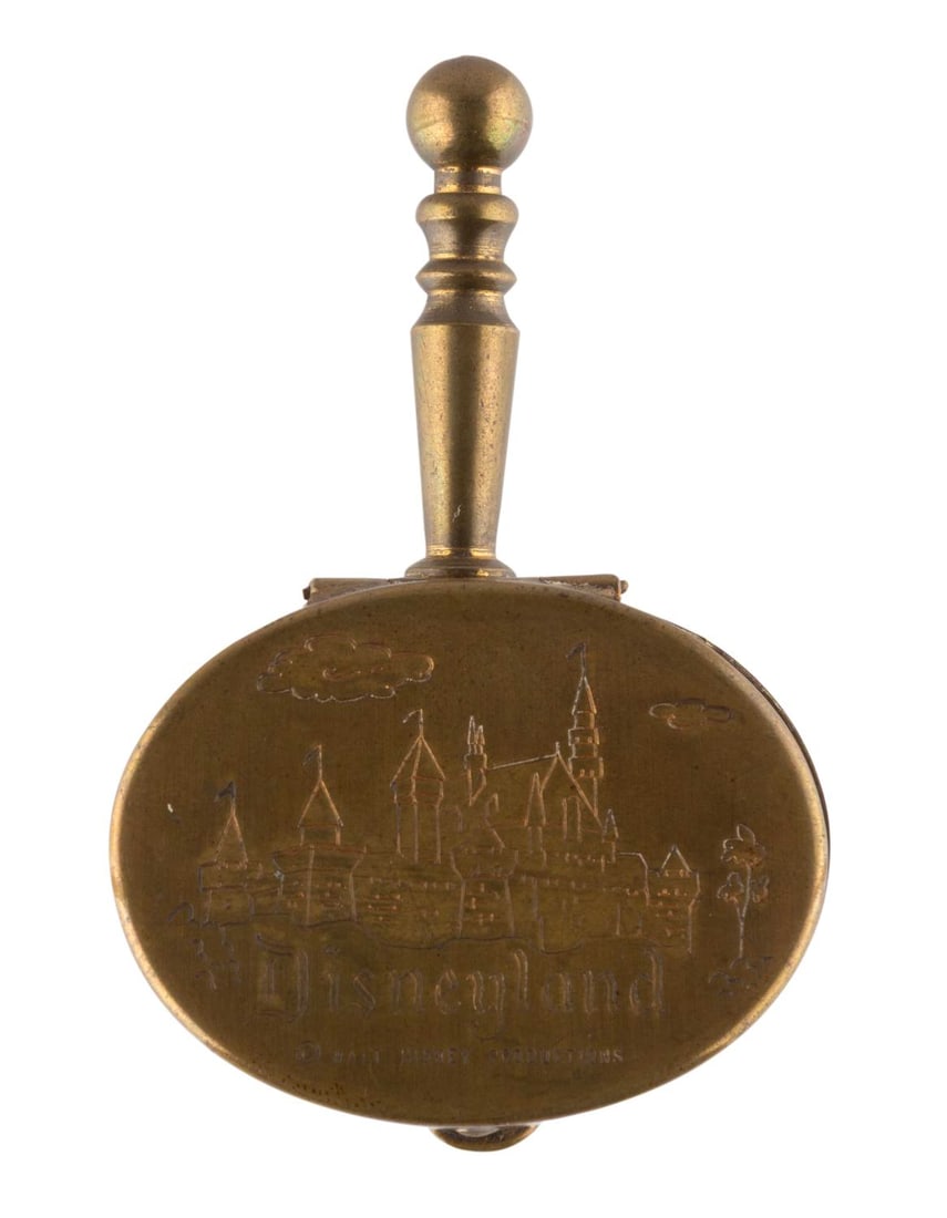 A Disneyland Souvenir Silent Butler Ashtray.: (Disneyland, 1960s) A Disneyland souvenir Silent Butler ashtray featuring Walt Disney's Sleeping Beauty Castle. Measuring 1.5" x 2.25", the souvenir is in very good condition with wear from use mainly