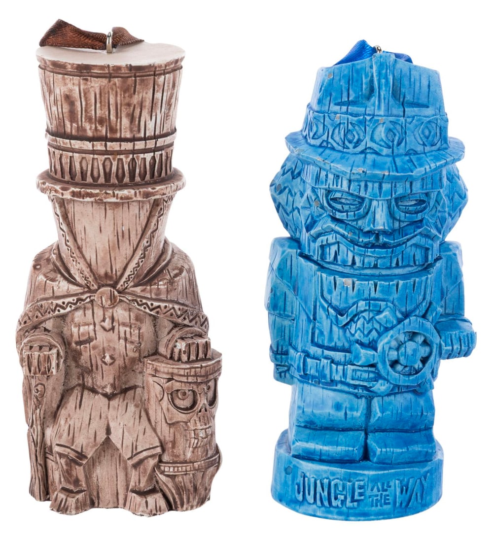 A Pair of Trader Sam's Enchanted Tiki Bar Ornaments.: (Disneyland Hotel, 2019) A pair of Jungle All the Way and 2nd Edition Hatbox Ghost ornaments, inspired by The Haunted Mansion and Jungle Cruise mugs released at Trader Sam's Enchanted Tiki Bar. Measur