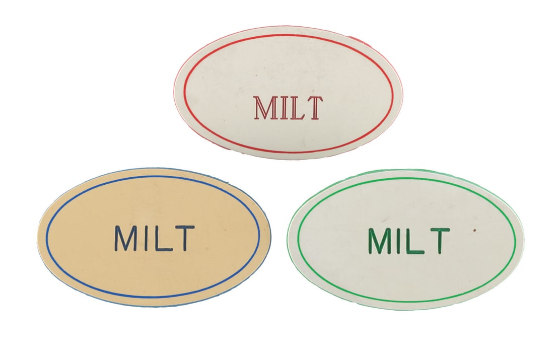 A Trio of "Milt" Disneyland Name Badge.: (Disneyland, 1980s-90s) Three "Milt" Disneyland name badges from the estate of Disney Legend Milt Albright. The set includes badges with red, blue, and green text and backings. Measuring 2.75" x 1.75"