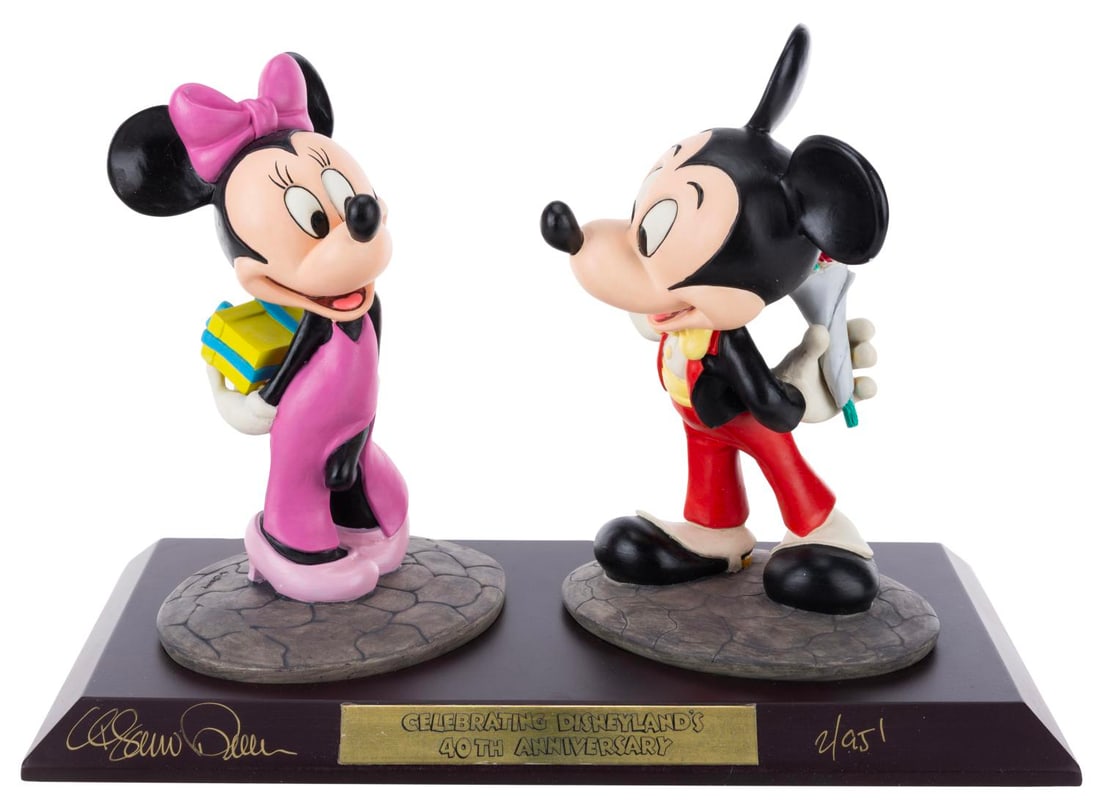 A Mickey and Minnie Mouse Limited Edition Figurine Set.: (Disneyland, 1995) A statue of Mickey and Minnie commemorating the 40th anniversary of Disneyland, released in a limited edition of 1500 pieces and signed by the artist Marc Delle. Measuring 7" x