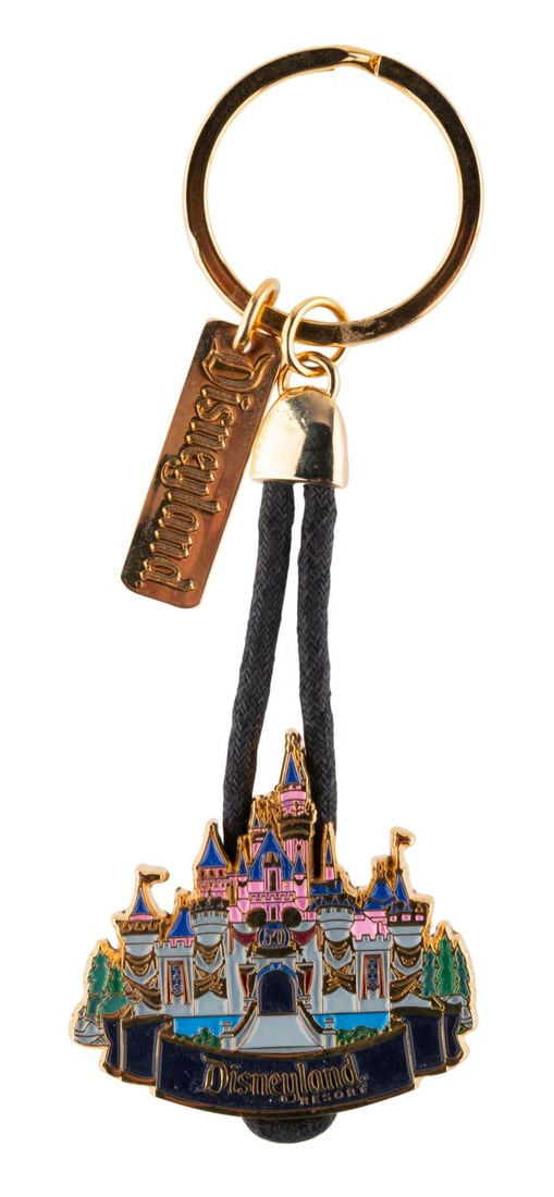 A Disneyland 50th Anniversary Keychain.: (Disneyland, 2005) A Sleeping Beauty Castle keychain commemorating the Disneyland Resort's 50th anniversary. Measuring 4.5" long including its chain and ring, the keychain is in very good condition