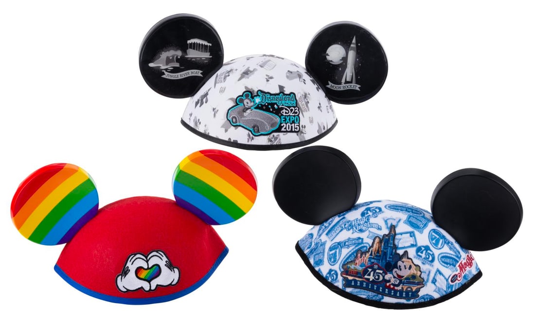 A Trio of Special Event Mickey Mouse Ears.: (Disneyland, 2000-2015) Three special event Mickey Mouse Ear hats. Included are ears from Disneyland 45th anniversary, D23 Expo 2015, and rainbow Pride Ears. Each labeled size "adult", the ears are