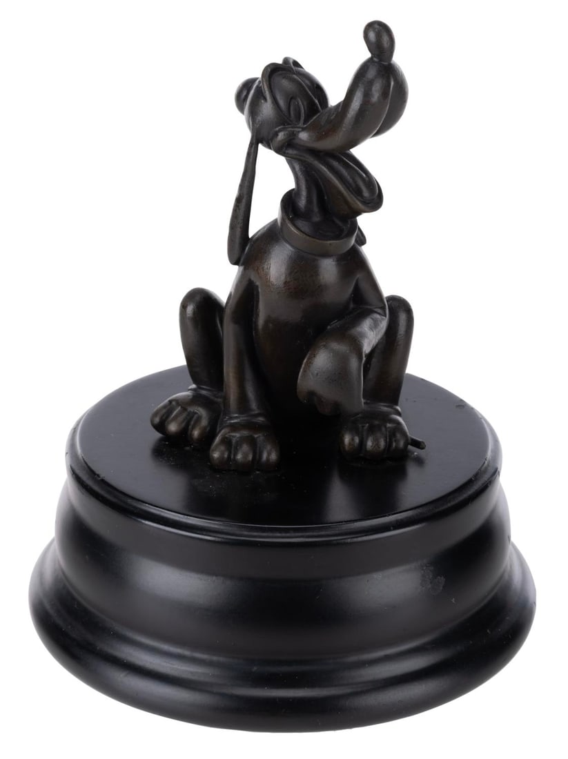 A Pluto Bronze Statue.: (Disney, 2000s) A bronze replica of the Pluto statue on display in the hub in front of Sleeping Beauty Castle at Disneyland. Measuring 6.5" tall and 5" in diameter, the statue is in good condition wit