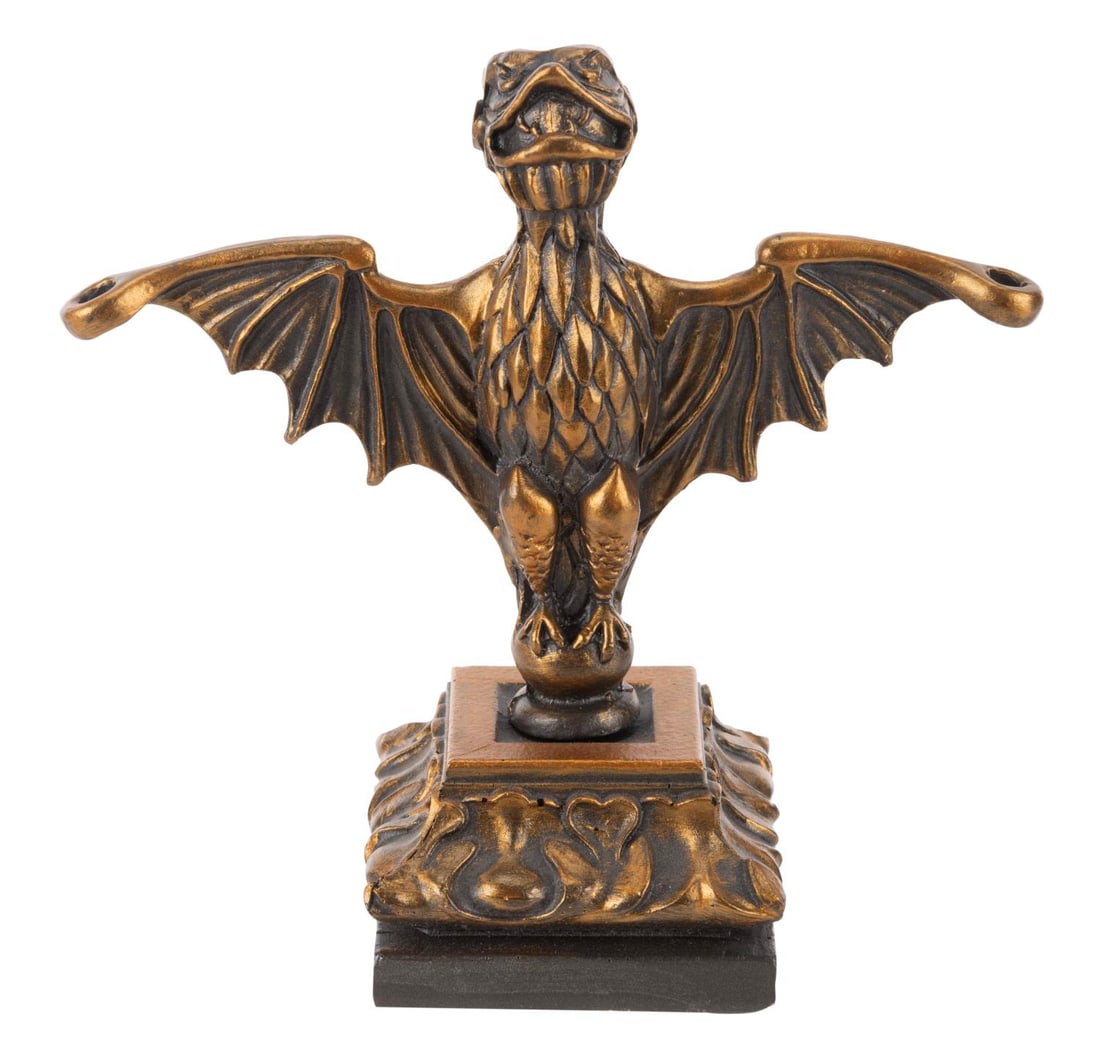 A Replica Haunted Mansion Bat Stanchion.: (2000s) A reproduction of the bat stanchion prop from Disneyland's Haunted Mansion. Likely a fan-made prop, the stanchion is accomplished in hand-painted metal and cast resin. Measuring 6" tall, the s
