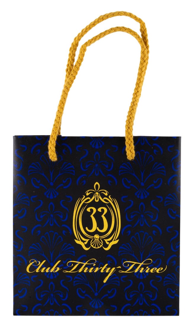 A Small Club 33 Shopping Bag.: (Disneyland, 2010s-20s) A small Club 33 gift bag featuring the updated logo printed in shiny gold lettering on the front and back. Measuring 3.5" x 6" x 6.5", the bag is in very good condition with li