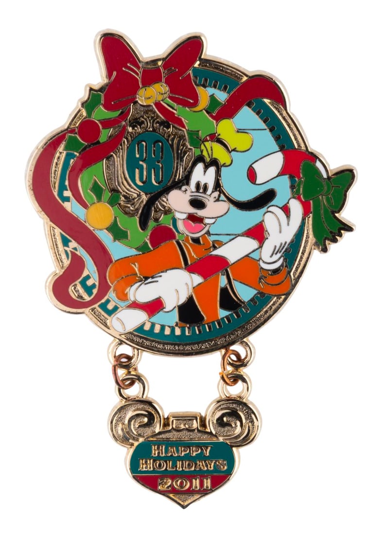 A Club 33 Goofy Happy Holidays 2011 Pin.: (Disneyland, 2011) A Club 33 Happy Holidays 2011 pin with a dangle feature, released only at the exclusive New Orleans Square eatery. The pin is in very good condition.