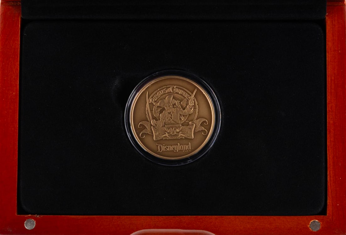 A Club 33 Pirates of the Caribbean 45th Anniversary Medallion.: (Disneyland, 2012) A Pirates of the Caribbean 45th Anniversary Medallion. This was available exclusively from Club 33 in a limited edition of only 125. The 39mm coin is minted from antique bronze and 