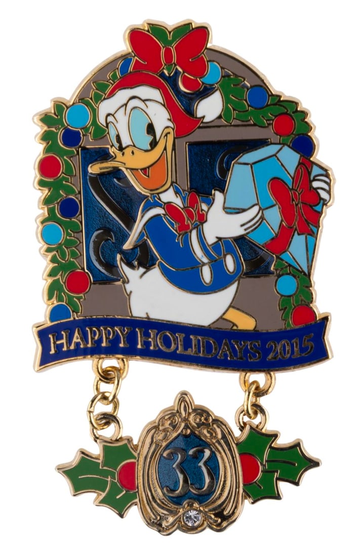 A Club 33 Happy Holidays 2015 Donald Pin.: (Disneyland, 2015) A Happy Holidays 2016 dangle pin of Donald Duck, released exclusively at Disneyland's Club 33 in a limited edition of 1500. The pin is in fine condition.