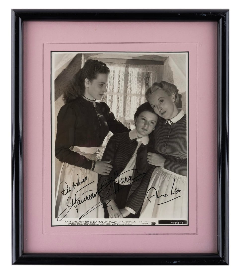 A Multi-Signed "How Green Was My Valley" Publicity Photo.: (20th Century-Fox, 1941) A framed publicity photo for the Best Picture Oscar-winning film "How Green Was My Valley," signed by stars Maureen O' Hara, Anna Lee, and Roddy McDowall. With a visible image