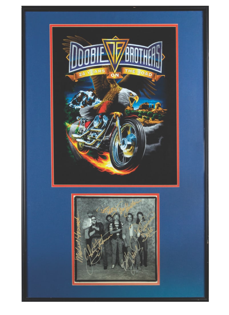 A The Doobie Brothers Signed Display.: (The Doobie Brothers, 1989/1995) A "Cycles" record insert signed by The Doobie Brothers, housed in a custom display featuring a 24 Years on the Road 1995 World Tour T-shirt. Included are signatures