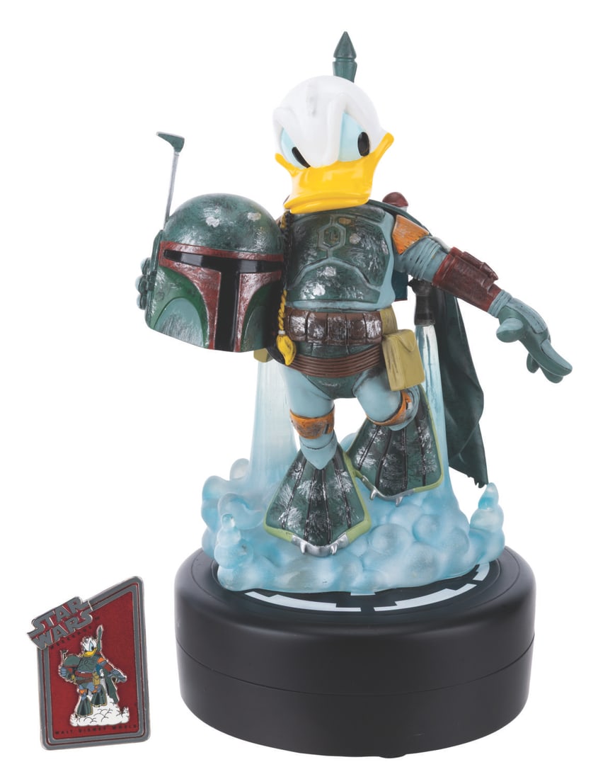 A Donald Duck as Boba Fett Medium Fig with Pin.: (Walt Disney World, 2013) A Medium Fig of Donald Duck as Boba Fett from "The Empire Strikes Back," designed by Disney artist Costa Alavezos. The figurine, released in a limited edition of 1977 at Star