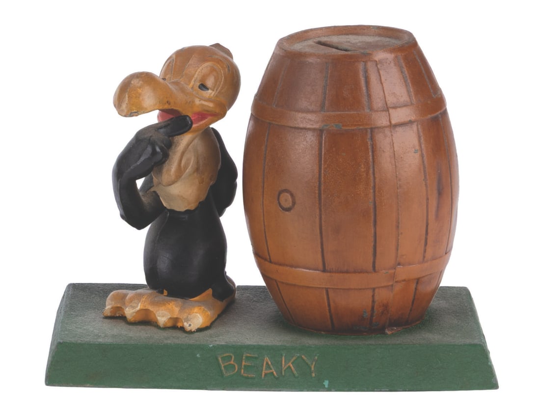 A Beaky Buzzard Metal Coin Bank.: (Metal Moss MFG., 1940s-50s) A hand-painted cast-iron coin bank featuring Warner Bros. star Beaky Buzzard. Beaky and the barrel-shaped bank are attached to a base that can be opened to release the sav