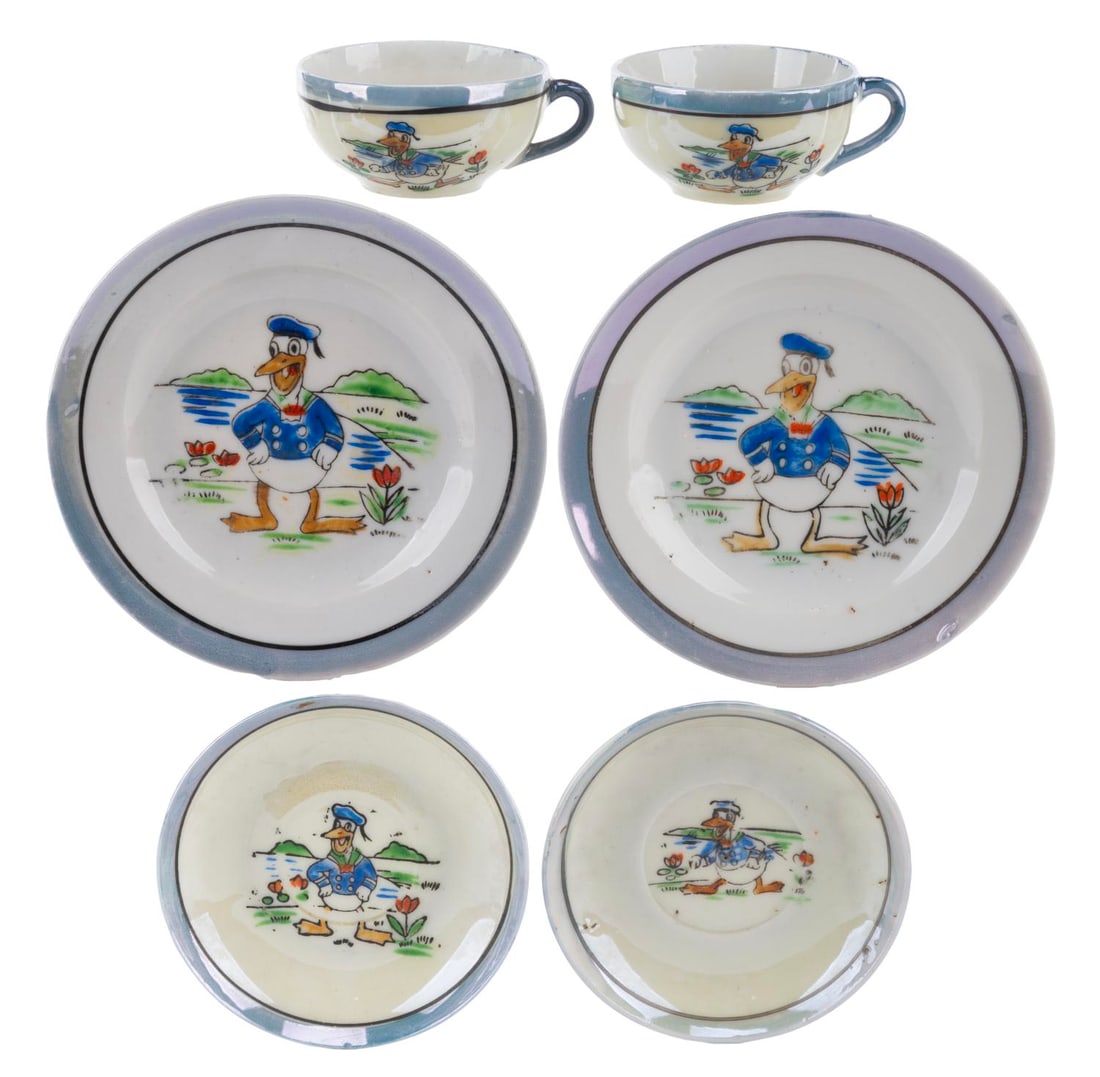 An Early Donald Duck Tea Set.: (Disney, 1930s-40s) A rare early Donald Duck tea set made of China. Included are two large saucers, two small saucers, and two teacups. Ranging in size from 2.25" in diameter to 4.25" in diameter and