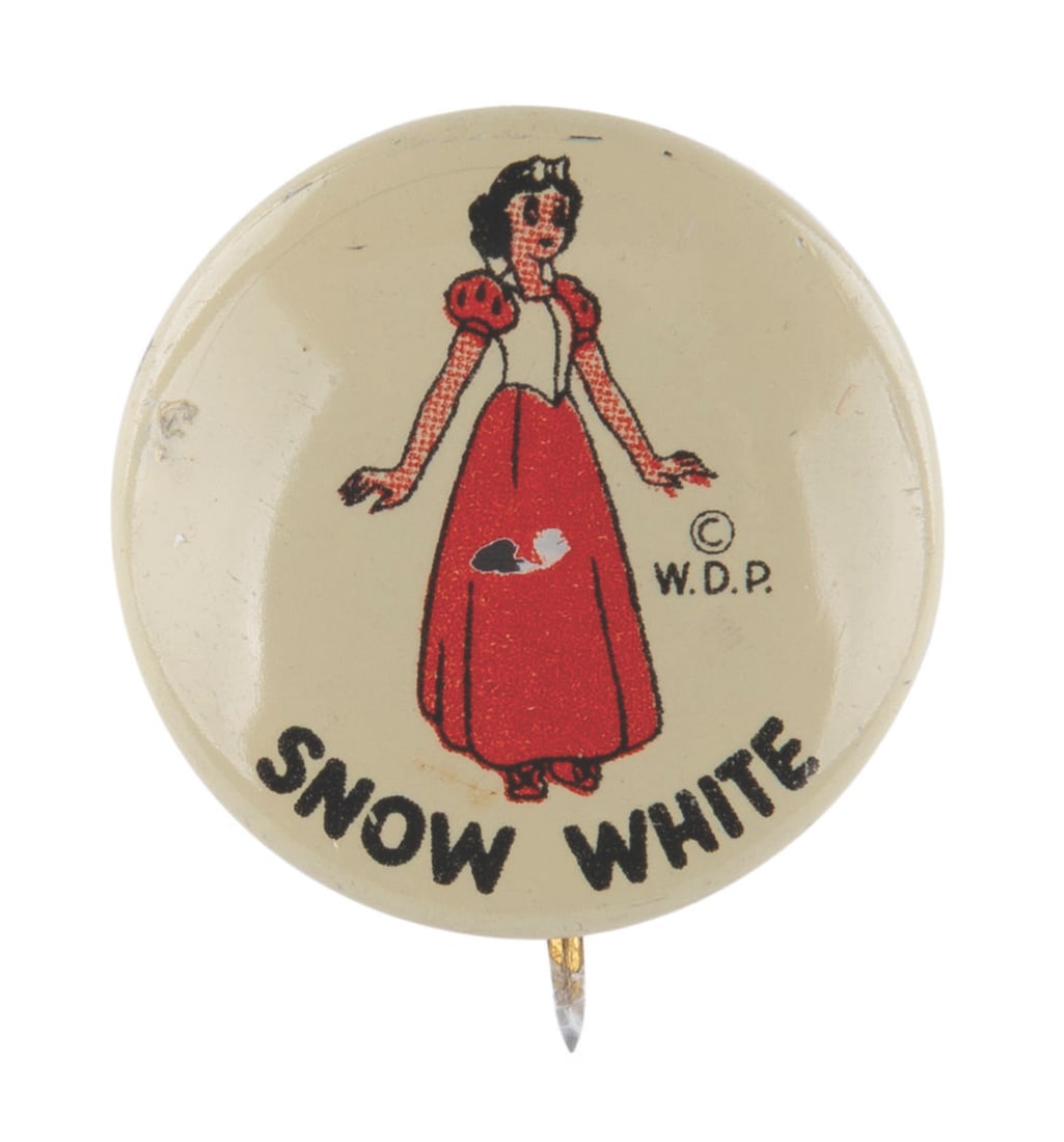 A Donald Duck Peanut Butter "Snow White" Button.: (Disney, 1950s) A pinback button featuring Snow White from a Donald Duck Peanut Butter premium. Measuring 0.75" in diameter, the button is in good condition with light paint wear.