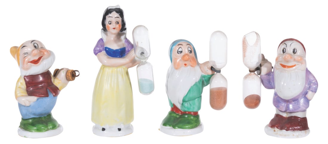 A Collection of Rare "Snow White" Egg Timer Figurines.: (LSM, 1938) A collection of four "Snow White and the Seven Dwarf" egg timer figurines of Snow White, Happy, Grumpy, and Sleepy, manufactured by LSM. Ranging in size from 3.25" x 4.5" tall, the figurin