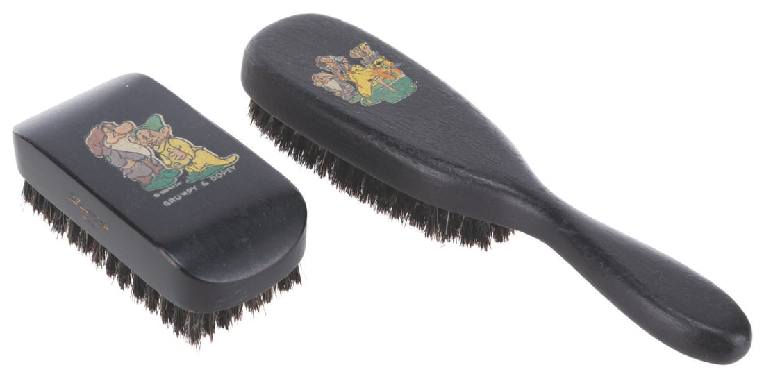 A Pair of "Snow White and the Seven Dwarfs" Brushes.: (Henry L. Hughes Co., 1938) A pair of rare "Snow White and the Seven Dwarfs" brushes manufactured by early Disney licensee Henry L. Hughes Company of New York. Ranging in size from 3.5" x 7" long, the
