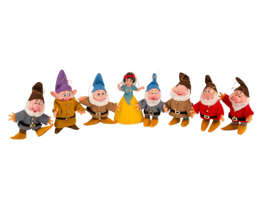 A "Snow White and the Seven Dwarfs" Ornament Set.: (Disney, 1960s-70s) A set of "Snow White and the Seven Dwarfs" Christmas Ornaments. Each ornament is flocked and features felt clothing. Snow White measures 1.75" x 2.75" X 4.5" tall, with each Dwarf 