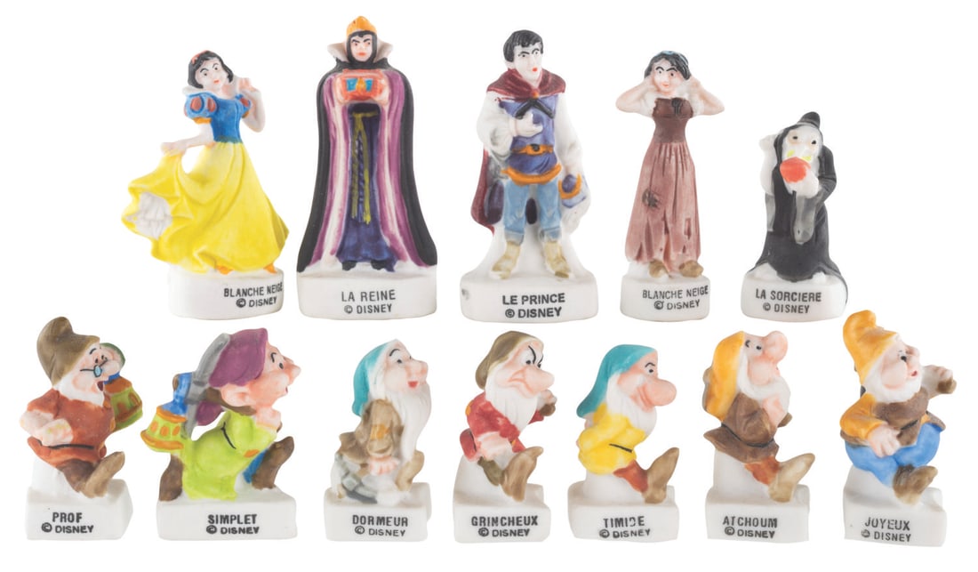 A Collection of Unfinished "Snow White" Epiphany F?ve Charms.: (Disney, 2000s) A collection of 12 "Snow White and the Seven Dwarfs" Epiphany Cake F?ve charms. Included are Snow White, Snow White in rags, the Evil Queen, Old Hag, the Prince, and the Seven Dwarfs. 