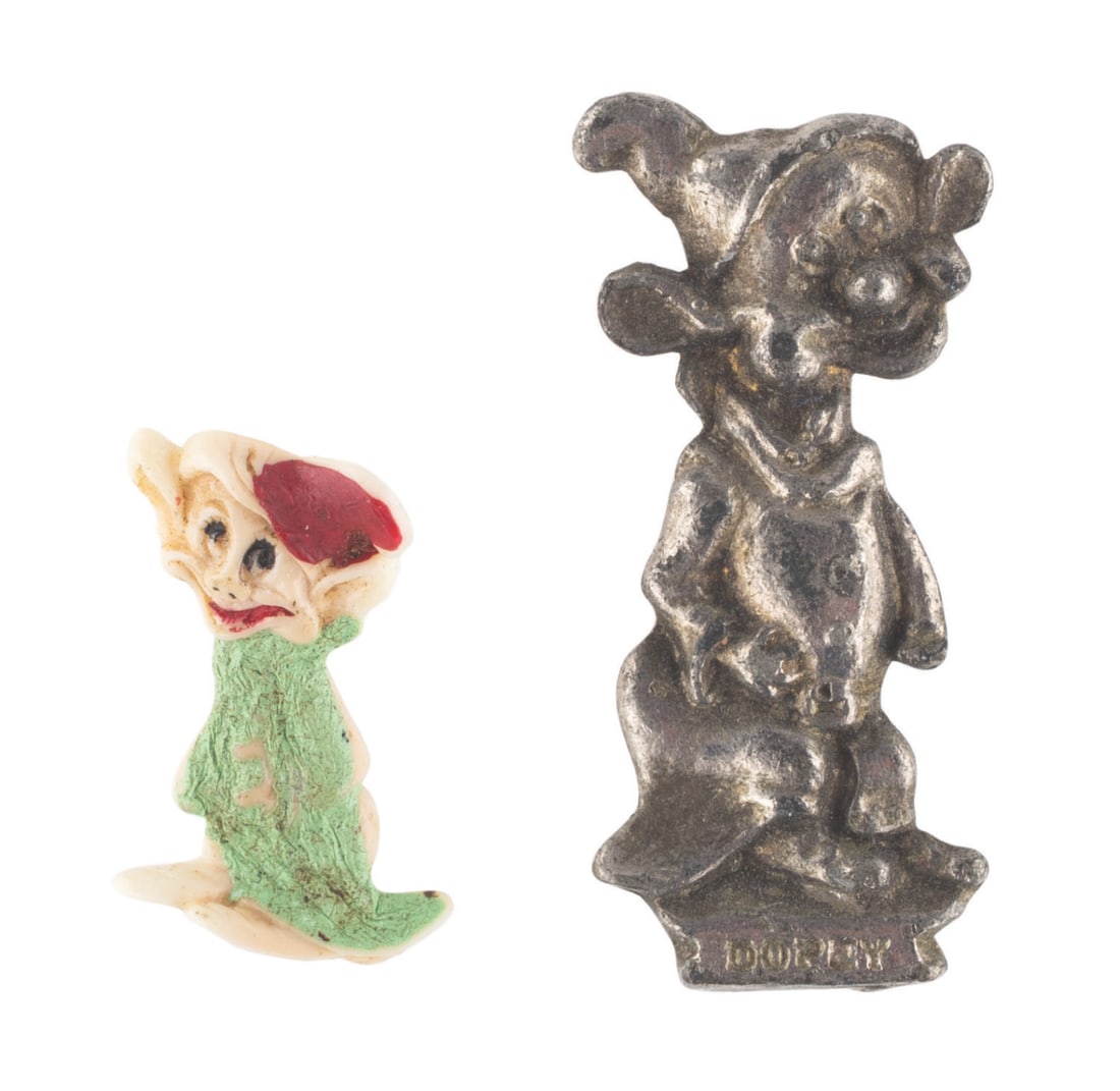 A Pair of Dopey Collectibles.: (Brier/Disney, 1930s) A pair of "Snow White and the Seven Dwarfs" Dopey collectibles, including a 1938 pin by Brier and a hand-painted charm. The items are in good to very good condition with wear and