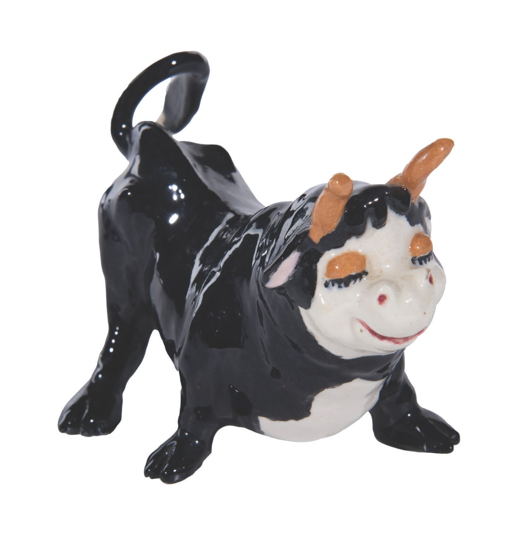 A Ferdinand the Bull Ceramic Figure.: (1940s-70s) A rare ceramic inspired by "Ferdinand the Bull." Measuring 5.5" x 3" x 3.25" tall, the ceramic bull is in very good condition with light wear and adhesives on the bottom of the hooves.