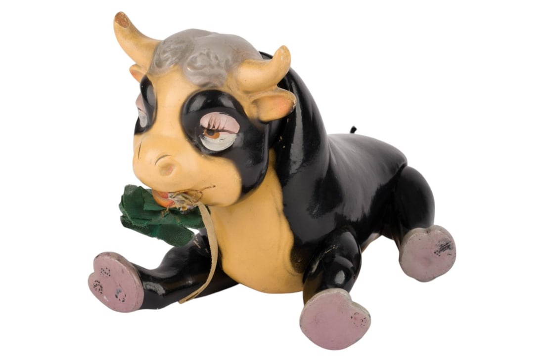 An Articulated Ferdinand the Bull Toy.: (Knickerbocker, 1930s) An articulated Ferdinand the Bull composition doll based on the 1938 Disney short film "Ferdinand the Bull." Measuring approximately 4" x 9.25" and 9" tall when standing, the to