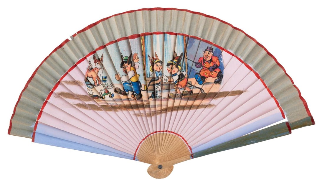A "Pinocchio" Donkey Scene Japanese Fan.: (Japan, 1950s-60s) A "Pinocchio" Donkey Scene Japanese fan, with a litho print image applied to wood with hand-painted elements. Measuring 7.5" x 13.5" open, the fan is in very good condition with