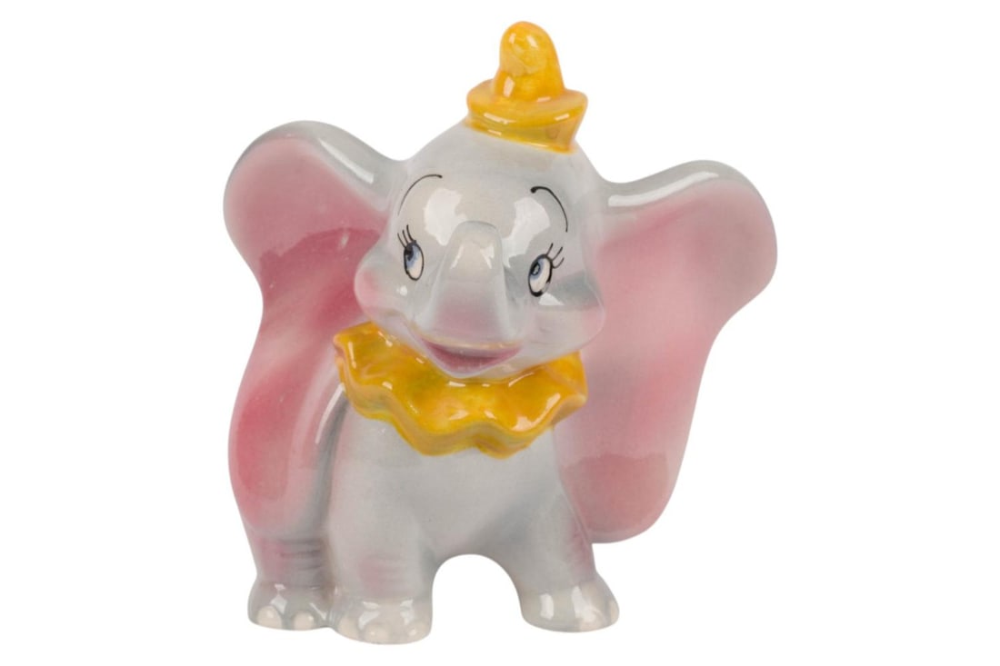 A "Dumbo" Ceramic Figurine by Shaw.: (Shaw, 1940s-50s) A painted and glazed ceramic figurine of "Dumbo" manufactured by Evan K. Shaw. Measuring 5" x 5" and 5.5" tall, the figurine is in very good condition with light soiling and crazing