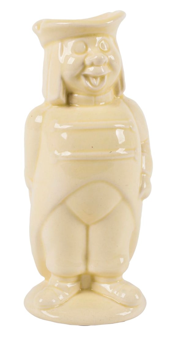A "Cinderella" Footman Ceramic Pitcher.: (Weetman, 1950s) A ceramic pitcher of a carriage Footman from "Cinderella," manufactured by Weetman Pottery. Measuring 2.5" x 3" and 6" tall, the pitcher is in very good condition with faint crazing.