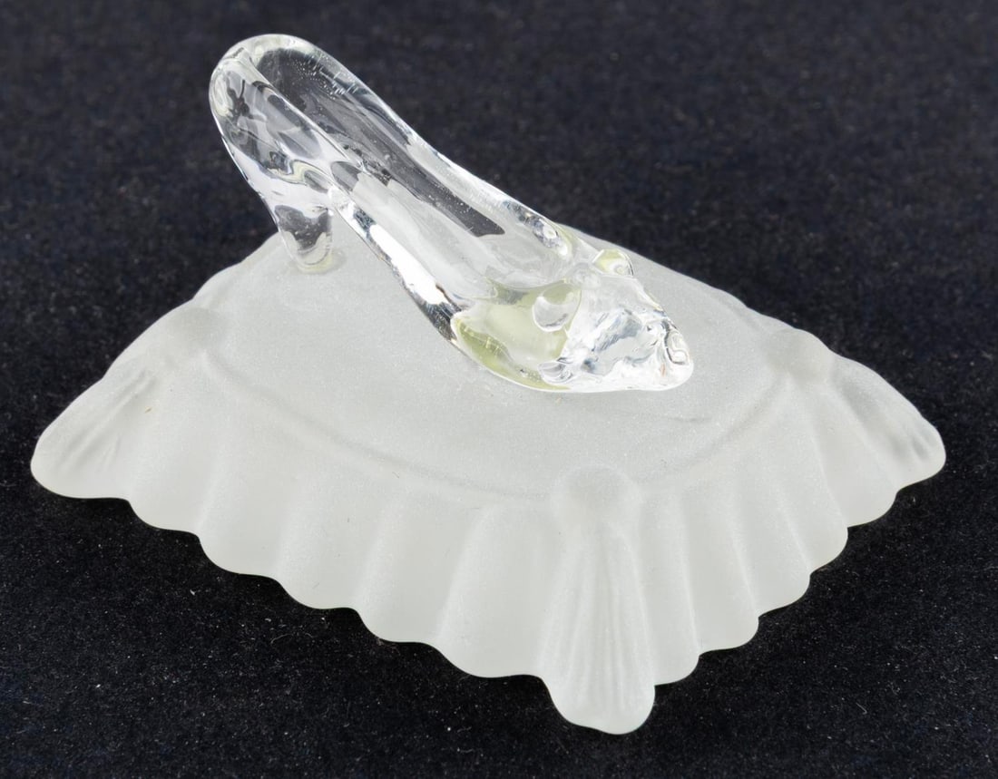 A "Cinderella" Arribas Bros. Slipper on Pillow.: (Arribas Bros., 1990s-2000s) A "Cinderella" glass slipper on a frosted pillow, originally sold at the Disney Parks. Measuring 1.75" x 2.25" x 1.5" tall, the piece is in fine condition.