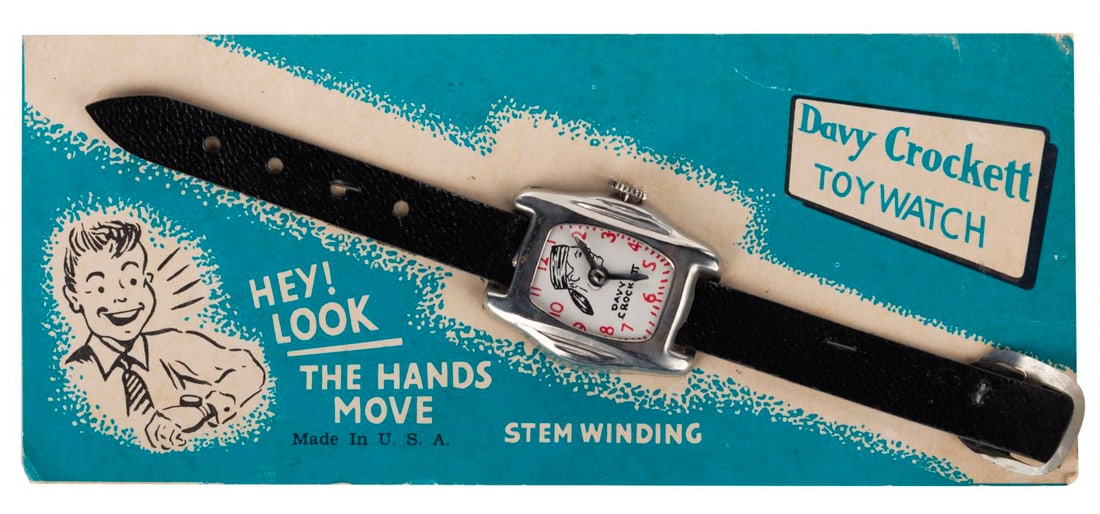 A Davy Crockett Toy Watch on Card.: (Unknown, 1950s) A Davy Crockett Toy Watch by an unknown manufacturer. The toy features a winding stem, but the hands no longer move. Measuring 7" long and 1.25" case, the toy is in very good conditio